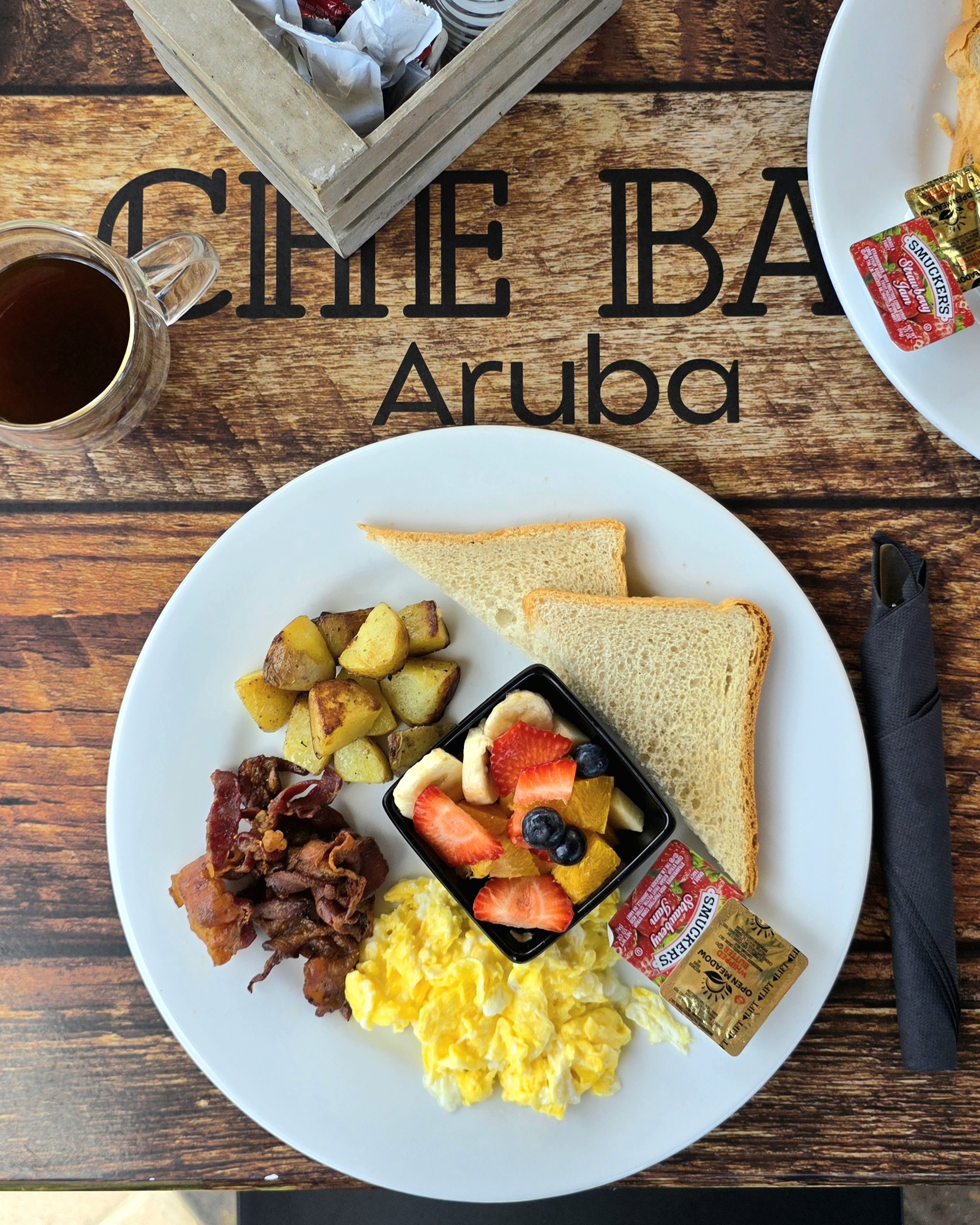 Che Bar Aruba big breakfast with scrambled eggs bacon potatoes toast and fruit